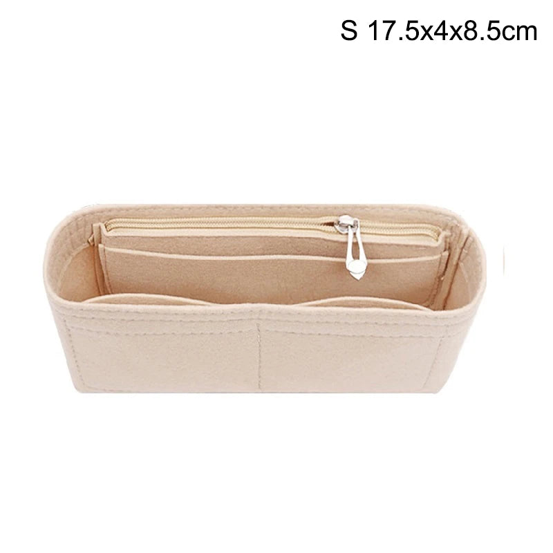 A light beige felt bag insert organizer with a zippered compartment.