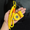 Yellow D-shape nylon fitness keychain with orange and yellow cord attached to a yellow sports bottle.