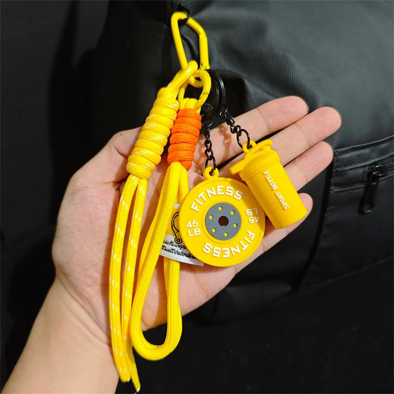 Yellow D-shape nylon fitness keychain with orange and yellow cord attached to a yellow sports bottle.