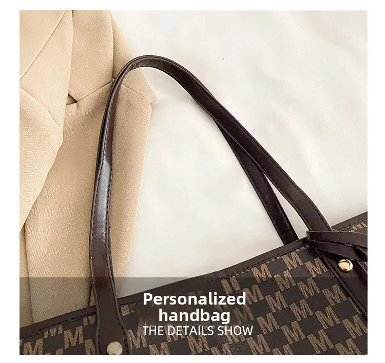 A close-up view of a brown faux leather handbag with a monogram pattern and a dark brown strap resting on a light background.
