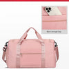 A pink travel duffle bag with a rear storage bag feature, shown from the front.