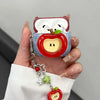 A hand holds a cute fruit design earphone case shaped like an apple, featuring white and red colors.