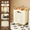 A large white foldable laundry basket with handles is shown on a floor, featuring a grid pattern and black accents.