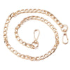 A gold-toned adjustable metal bag strap chain laid out in a circular shape.