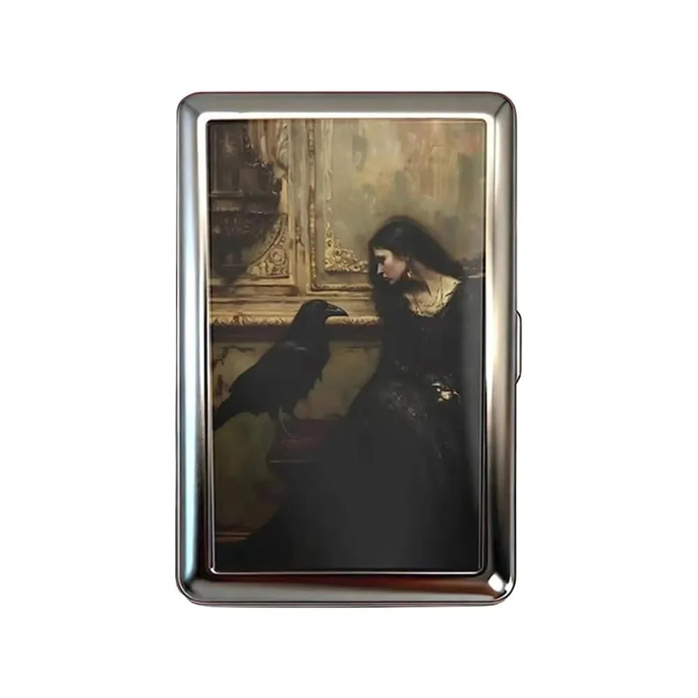 A vintage snap metal card holder featuring an antique portrait of a woman and a bird.