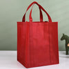 A bright red reusable eco-friendly tote bag standing upright on a white surface.