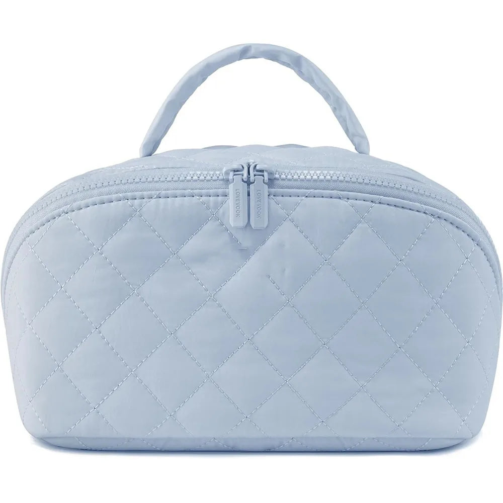 Light blue quilted lay-flat water-resistant makeup organizer bag with a handle