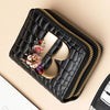 Black quilted PU leather clutch wallet with a gold logo and floral print