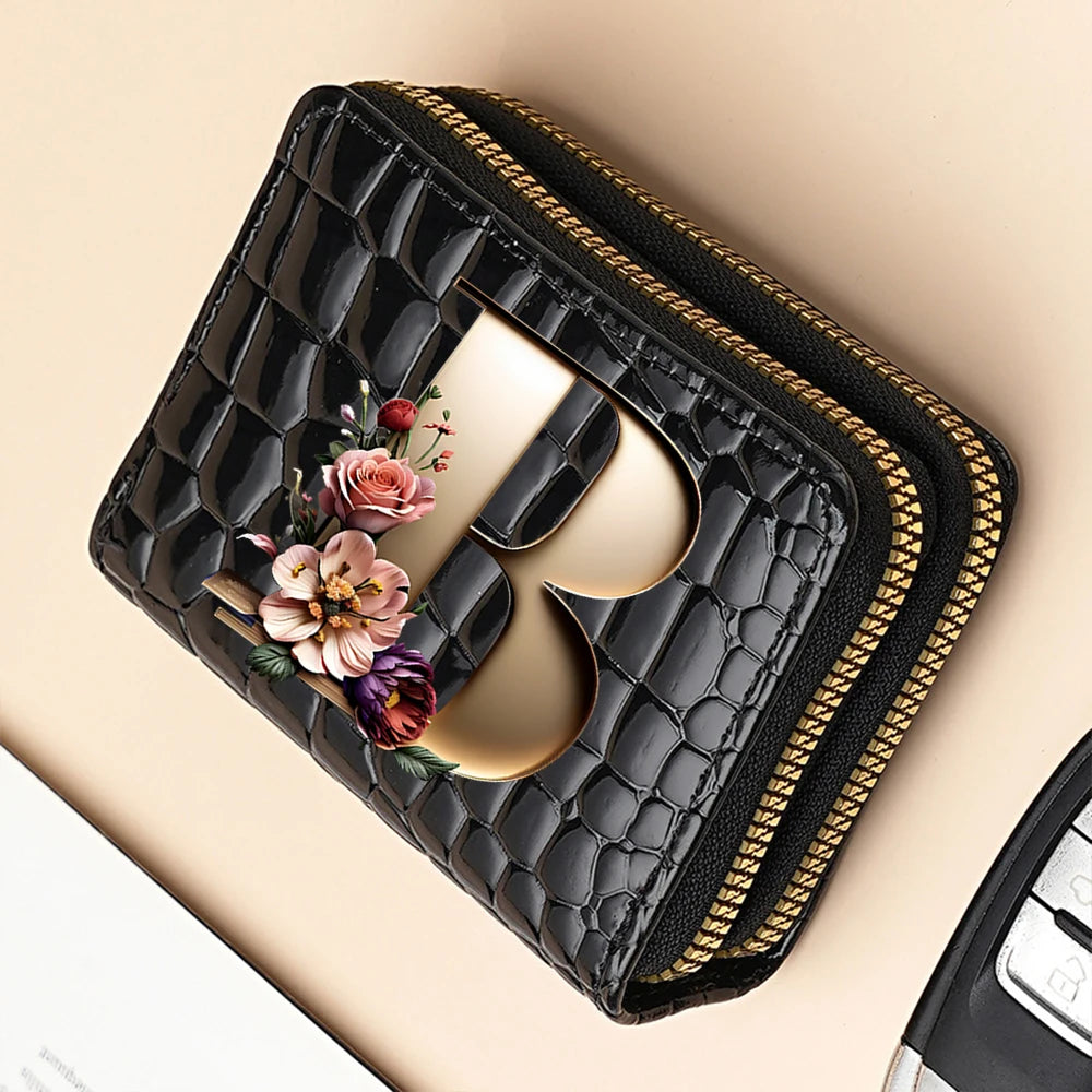 Black quilted PU leather clutch wallet with a gold logo and floral print