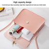 A pink fashion square crossbody bag is shown open, holding a smartphone and a white accessory.