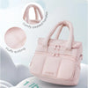 A pink quilted insulated lunch bag with padded handles is shown against a white background.
