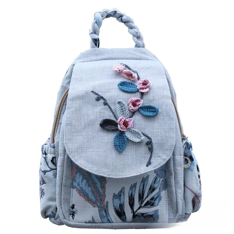 Light blue linen backpack featuring pink and blue floral embroidery