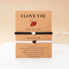 Two beaded friendship bracelets on kraft paper with 'I love you' messages for couples