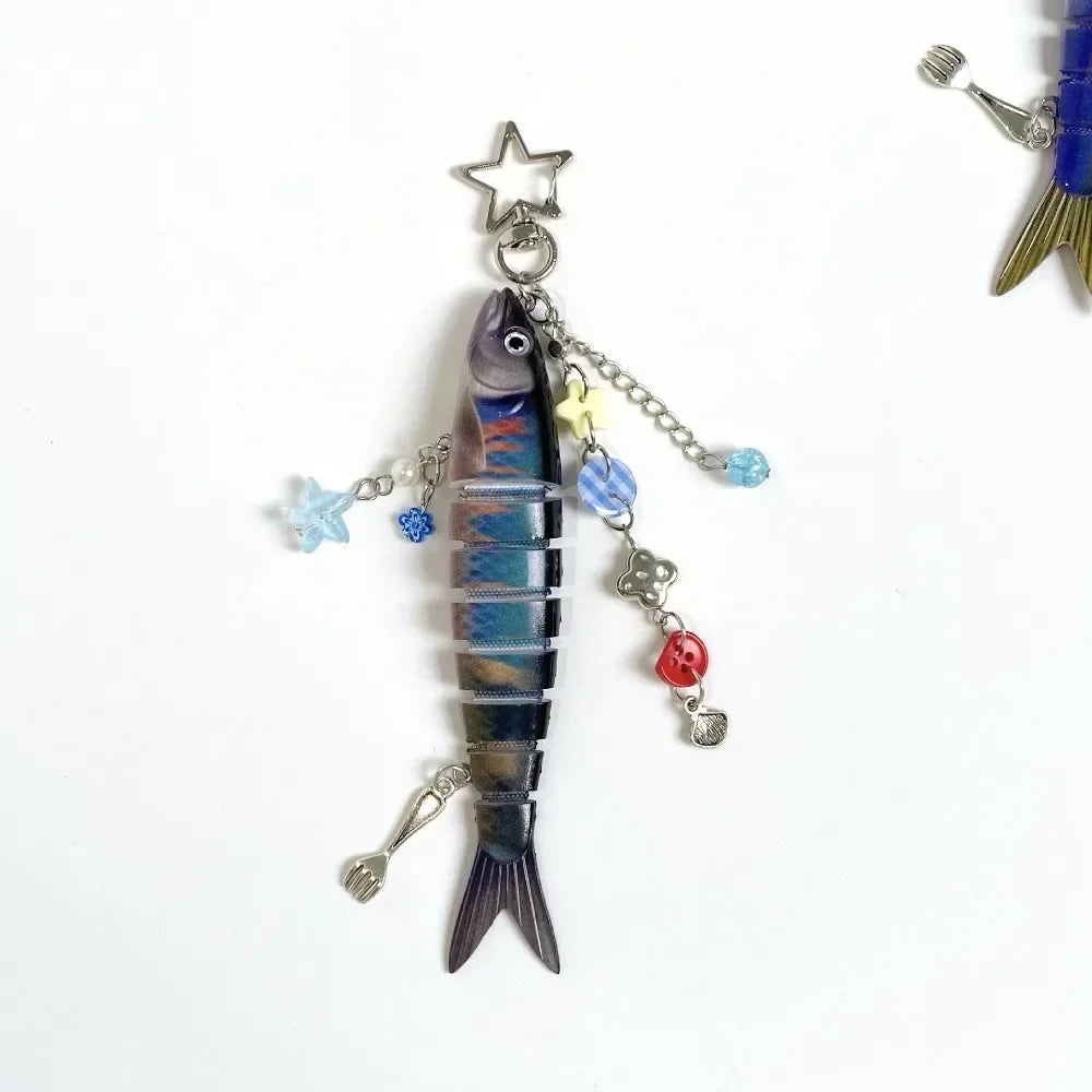 Silver simulation fish keychain with a star charm and various dangling charms