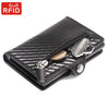 Black carbon fiber wallet with a zipper closure and a metal key attached.