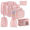 A set of multi-size mesh packing cubes in pink and white stripes for travel organization.