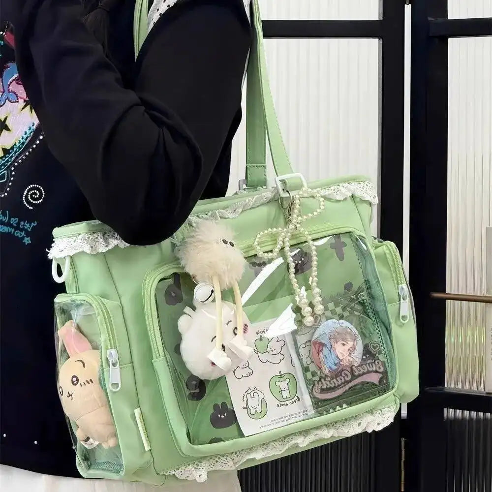 A light green transparent shoulder tote bag with decorative elements and a fluffy white charm is carried by a person.