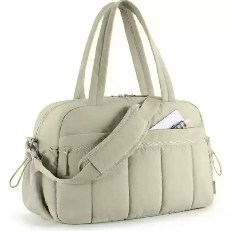 A beige versatile large capacity travel and fitness bag with padded straps.