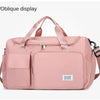 A pink large capacity travel duffle bag with an oblique display feature and shoulder straps.