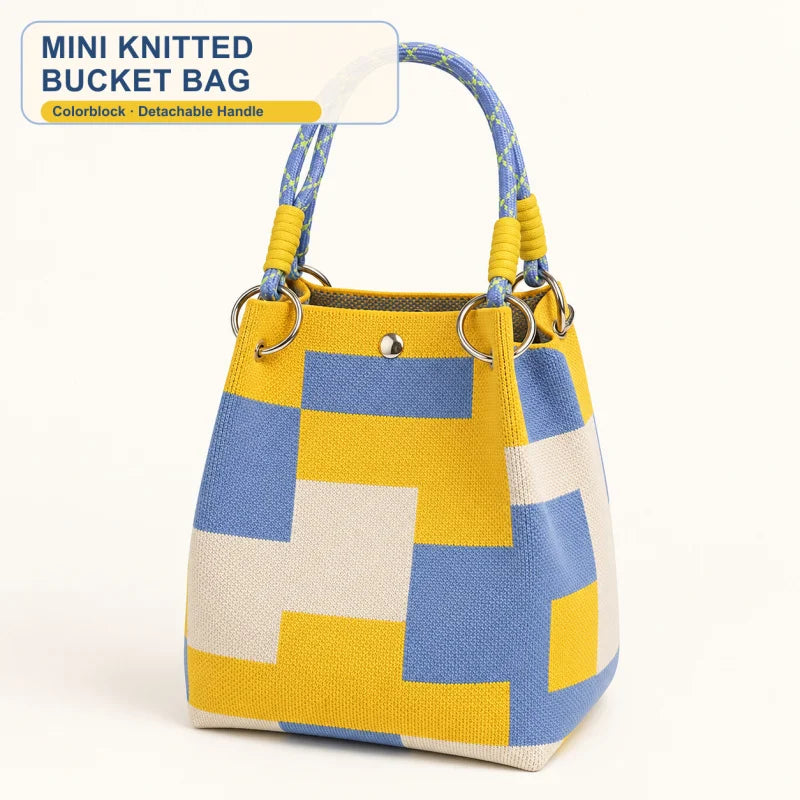 A yellow and blue geometric colorblock knitted bucket bag with a detachable handle.