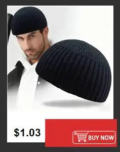 A close-up of a man wearing a black slouchy knit beanie hat.