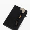 A black minimalist magnetic wallet for men with a gold coin visible through the transparent flap.