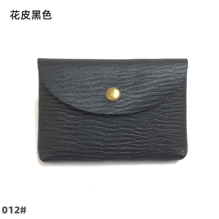 Black genuine leather card holder with a brass stud closure.