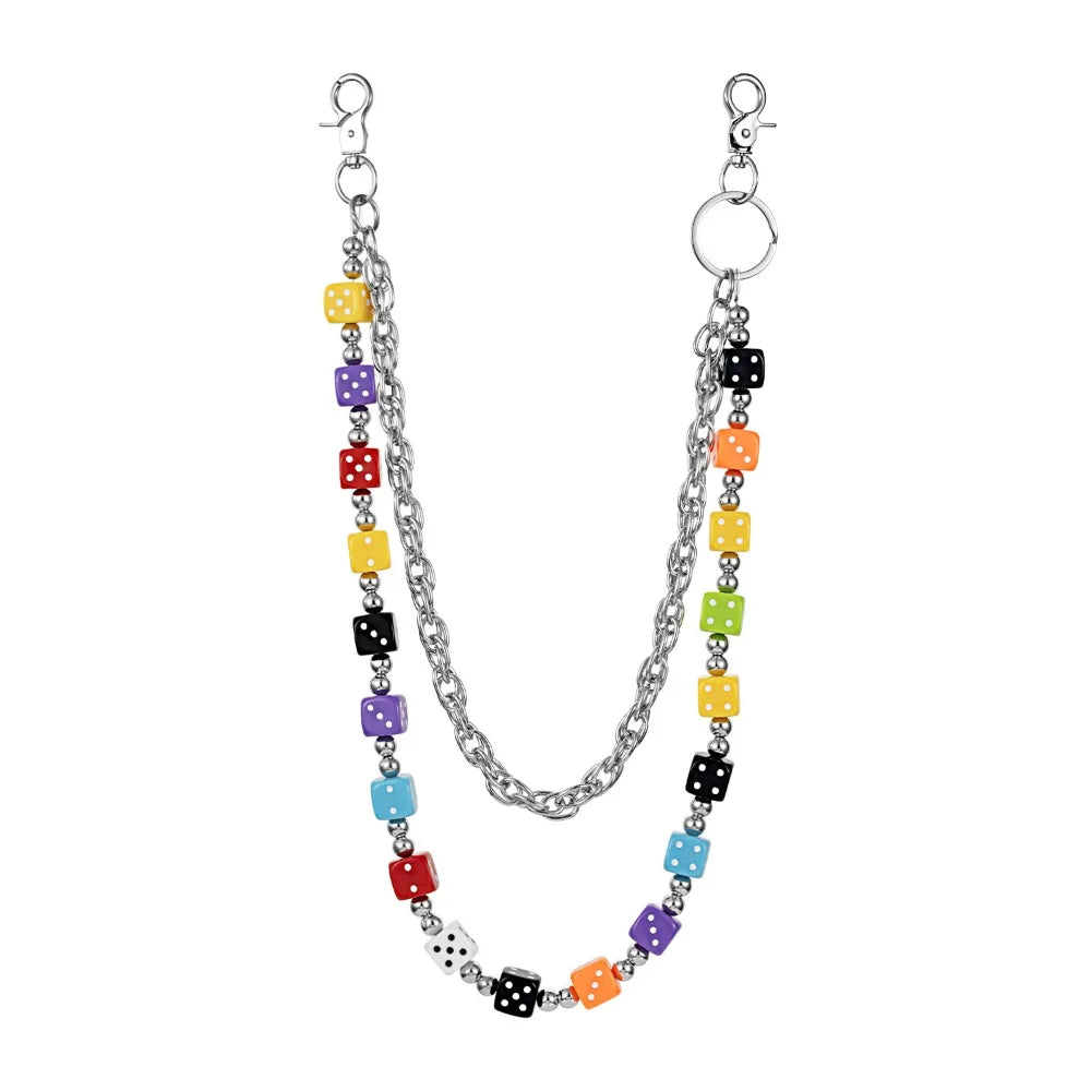 A silver chain necklace featuring colorful dice charms in yellow, purple, black, and orange.