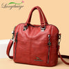 A reddish-brown leather fashion backpack bag with silver hardware shown in a studio setting.