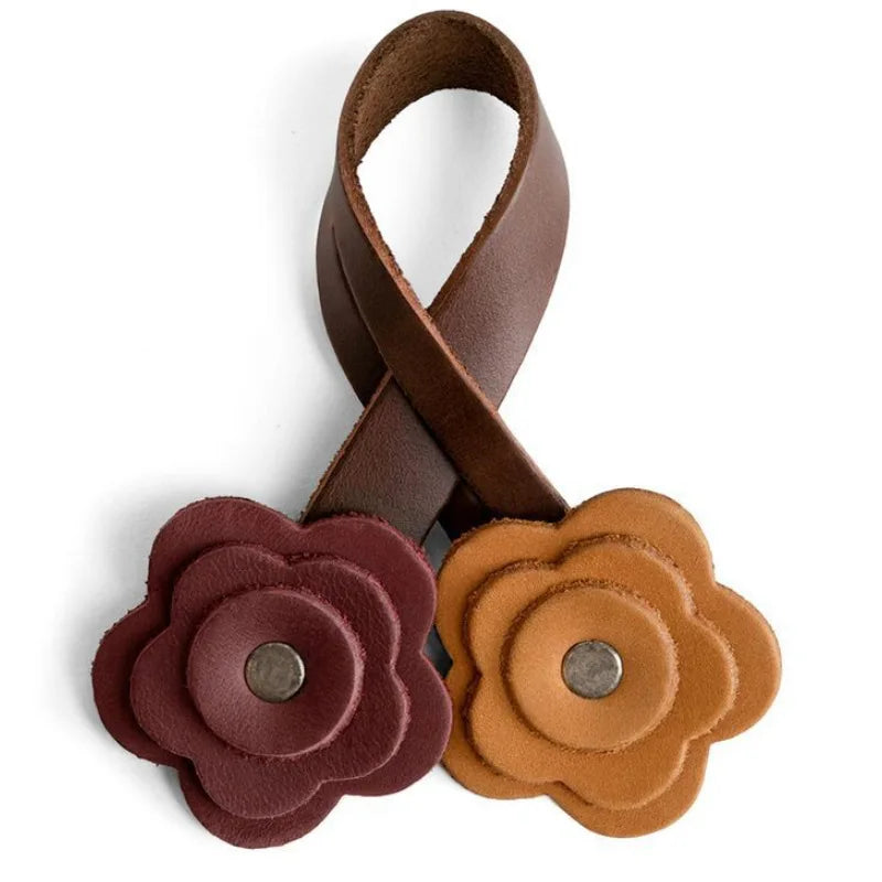 A handmade brown PU leather rose bag charm with a textured, layered design.