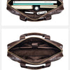 A brown full-grain leather executive laptop briefcase shown open, displaying internal organization and compartments.