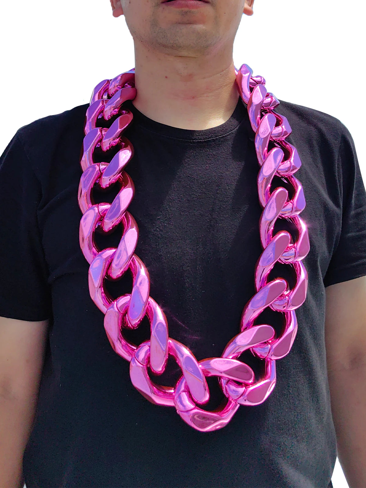 A man wearing a chunky pink acrylic Cuban link necklace around his neck.
