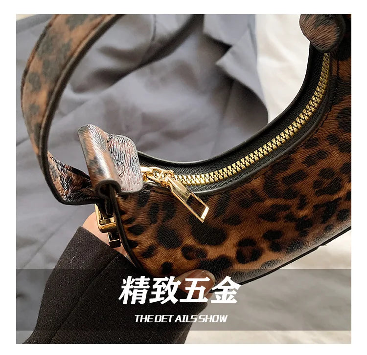 A close-up of a leopard print PU leather mini tote handbag with gold hardware and a yellow zipper on the top.
