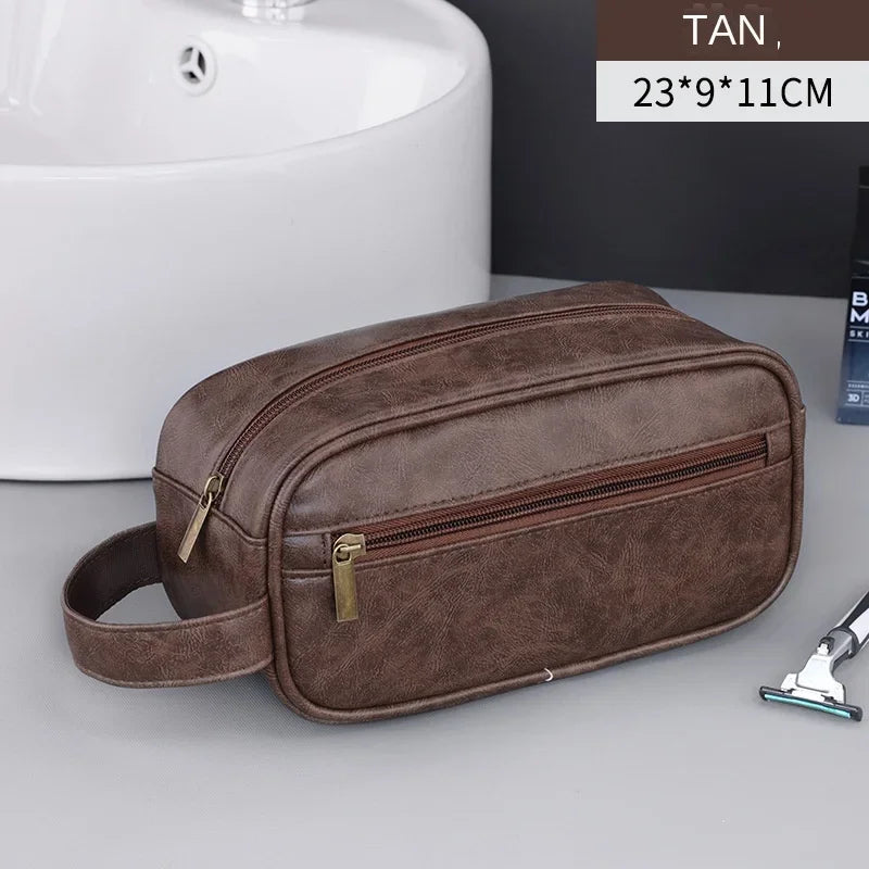 A brown leather travel cosmetic bag with a zipper and leather strap is shown next to a white sink.