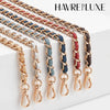 Multiple strands of braided leather and metal straps in various colors are displayed on a white surface.