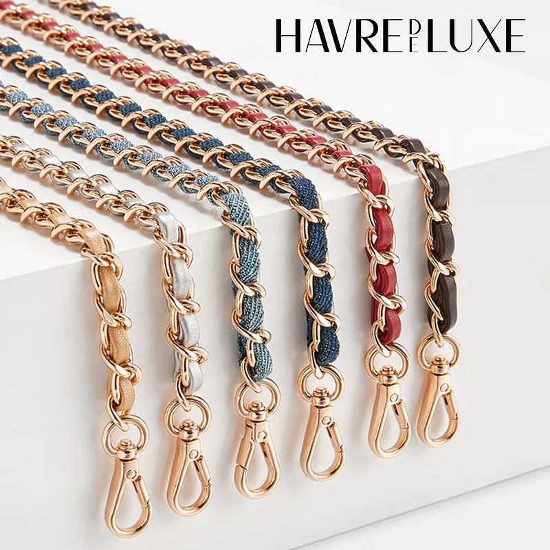 Multiple strands of braided leather and metal straps in various colors are displayed on a white surface.