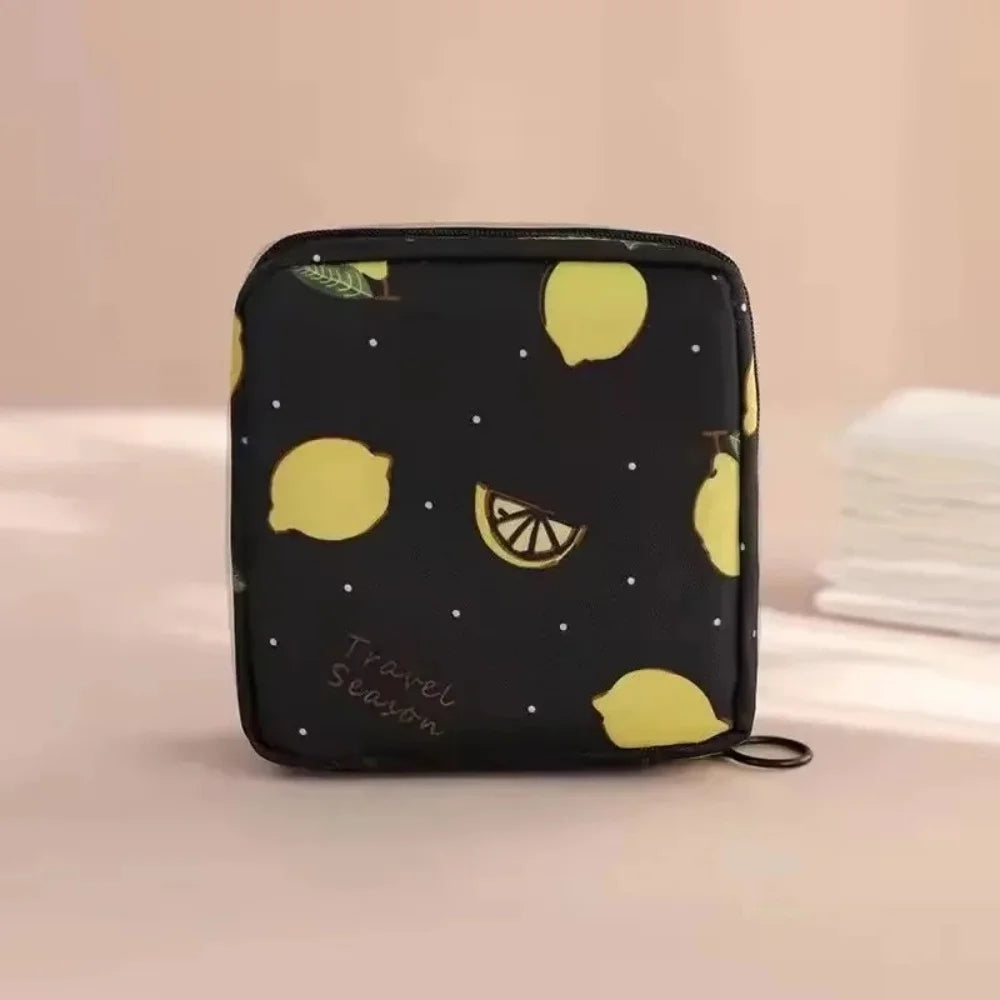 Black pouch with a yellow lemon pattern used for storing sanitary napkins.