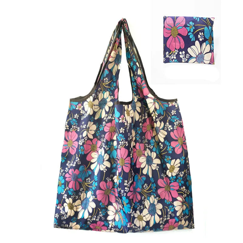 A reusable nylon tote bag featuring a floral print with pink, purple, and blue flowers.