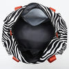 A black and white striped nylon travel duffle bag shown open, revealing the interior.