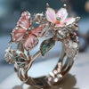 Silver rings featuring delicate pink and white flower and butterfly designs