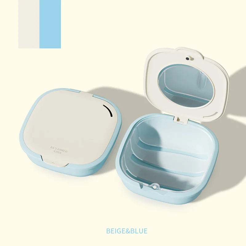 A light blue denture storage box with a mirror and drainage feature shown in an open and closed view.