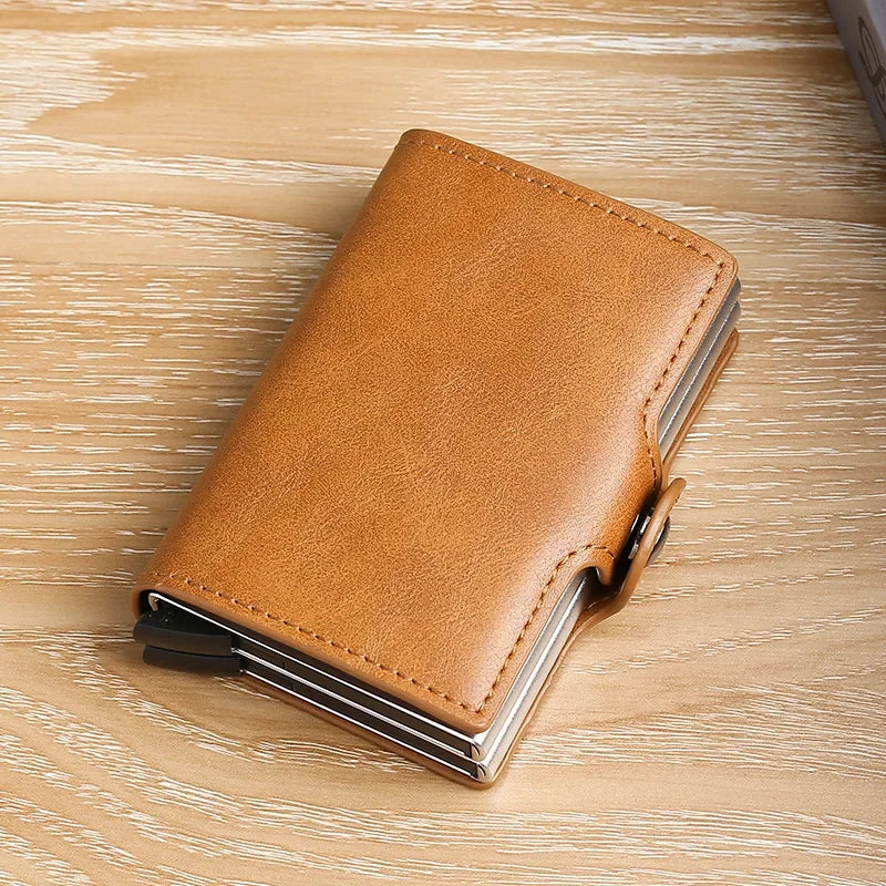 A brown leather double layer ID card holder wallet lying on a light wooden surface.
