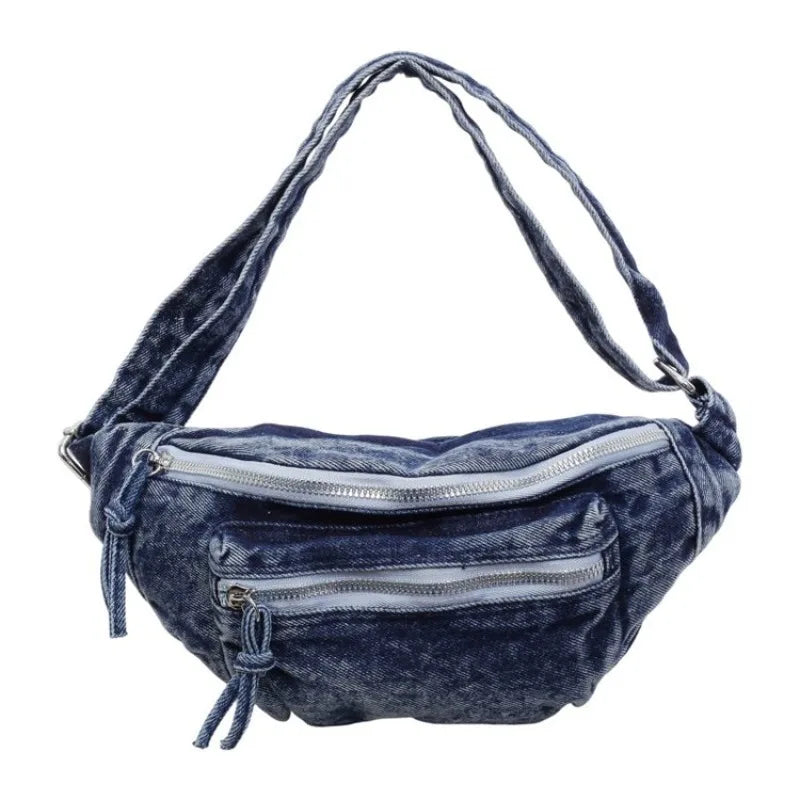 Sac bandoulière en denim vintage bleu foncé, lavé, avec fermeture éclair argentée et sangle réglable.