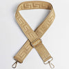 A tan woven strap with a maze pattern is shown in an X-shaped configuration.
