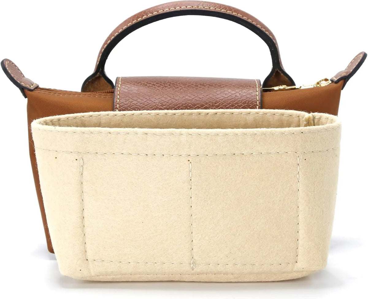 Kit de correa de cuero beige claro con asa de cuero marrón y sección rectangular a juego.