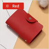 A red premium PU leather ID and credit card wallet lying on a light beige surface.