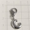 Silver stainless steel alphabet letter charm with a lobster clasp placed on a ruler.