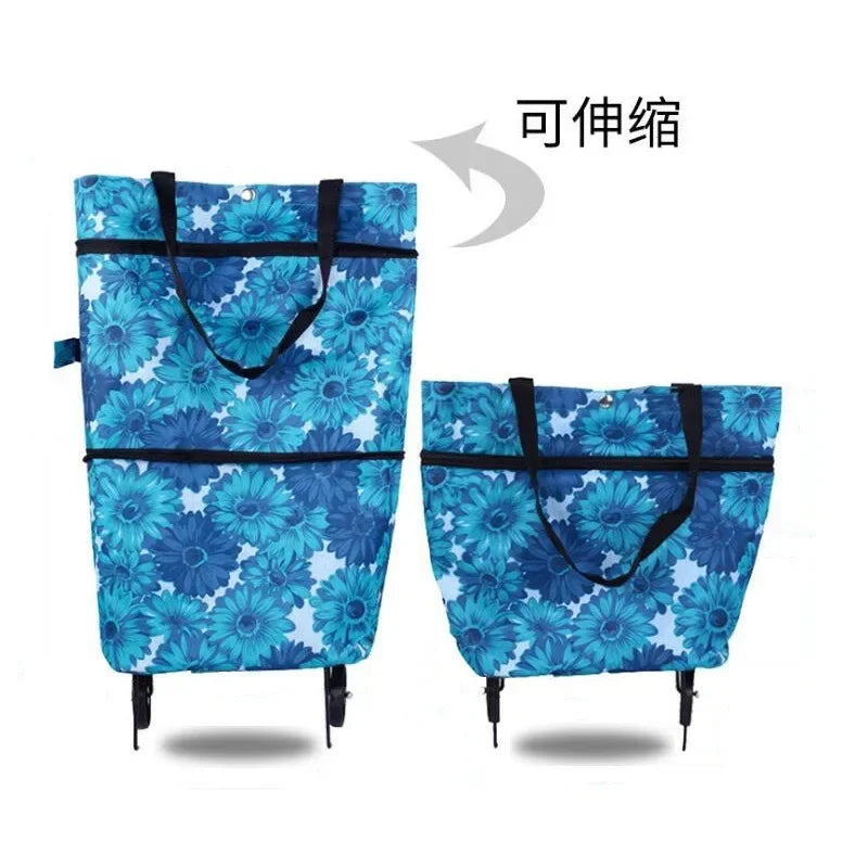A blue floral patterned folding shopping trolley bag with black handles.