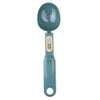 A teal digital kitchen scale with a round weighing platform and a handle.