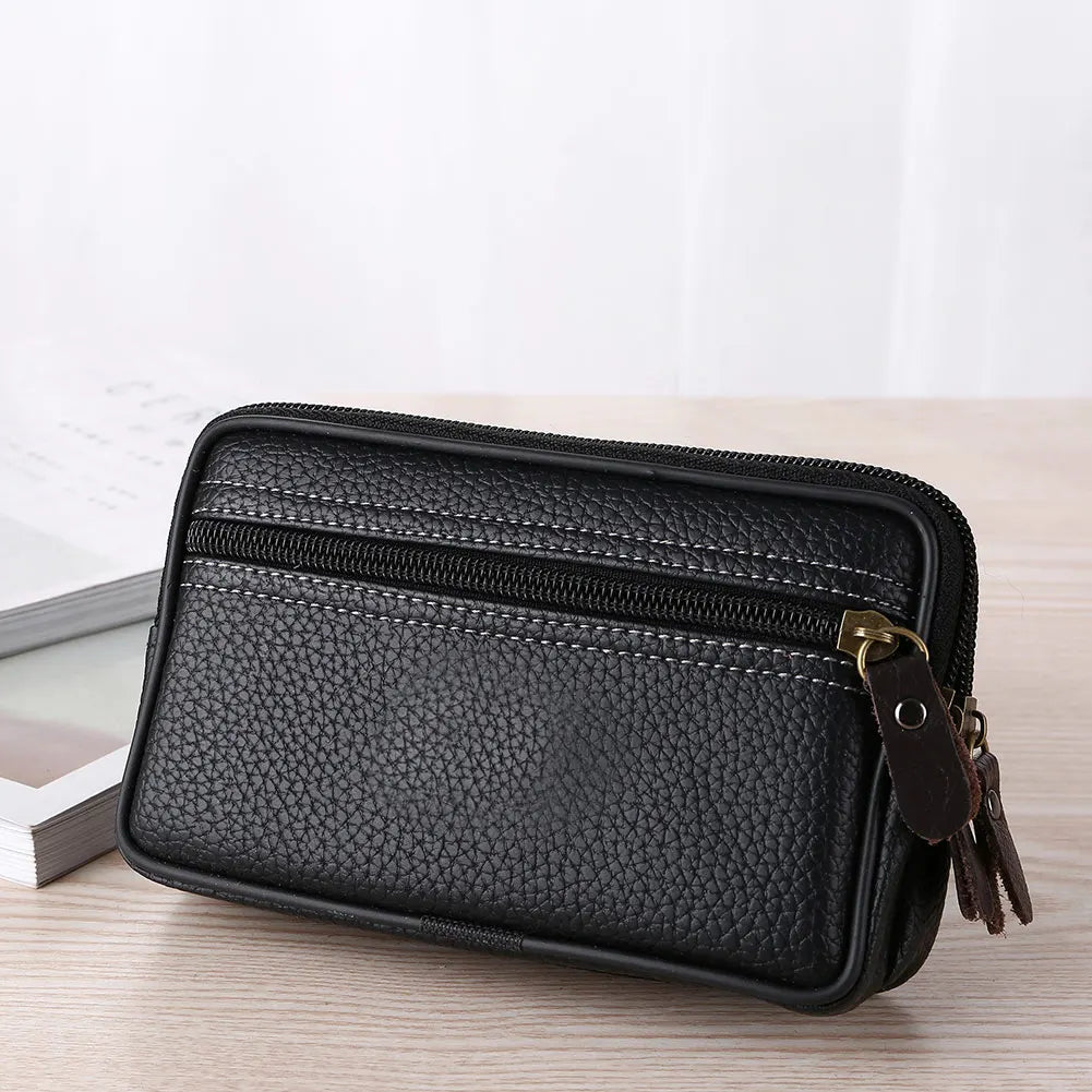 Black multi-function PU leather waist bag with a zipper and leather strap resting on a wooden surface.